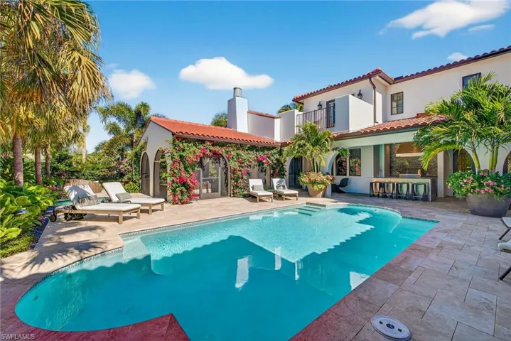 Outdoor pool with a patio and a bar