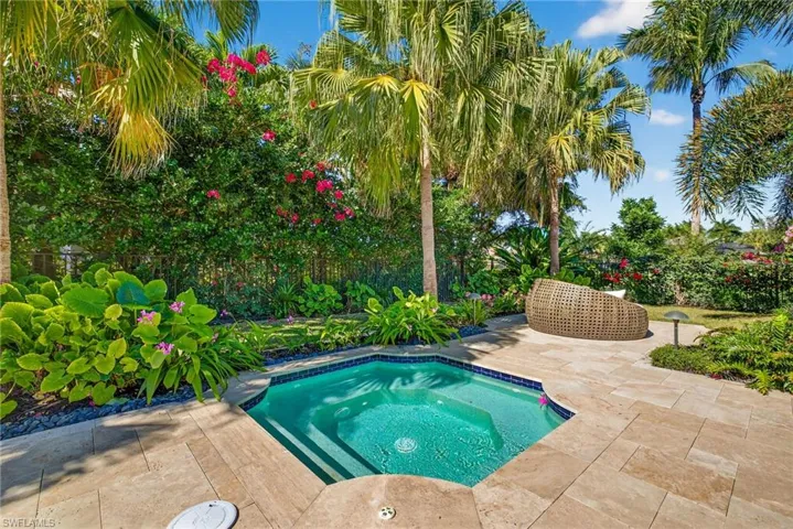 View of swimming pool with a fenced backyard, a patio area, and an in-ground hot tub