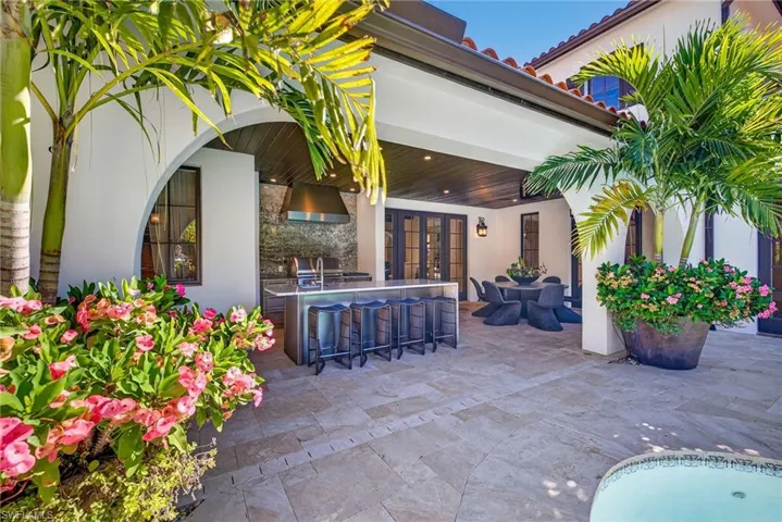 View of patio / terrace featuring french doors, outdoor dining space, and an outdoor kitchen