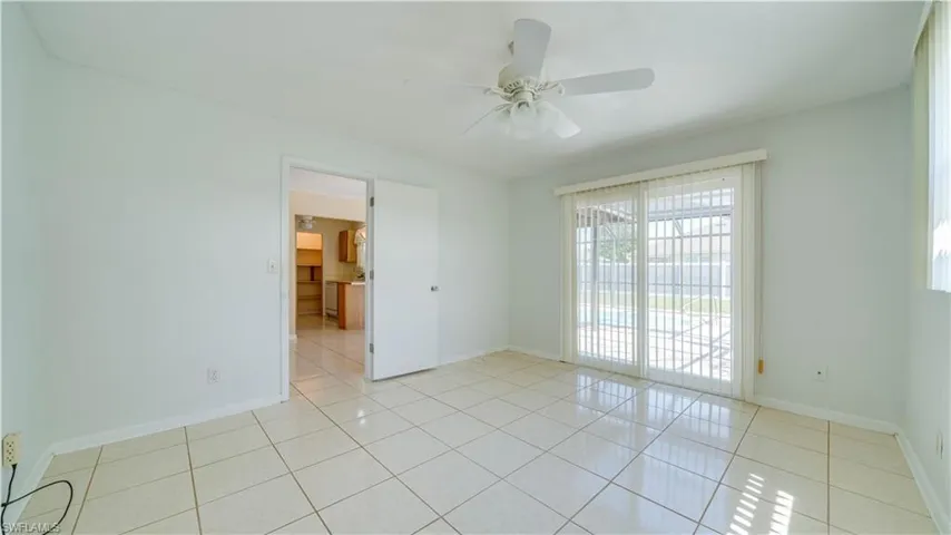 Primary bedroom with sliding door to lanai and pool