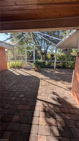 View of patio / terrace featuring a sunroom and a lanai