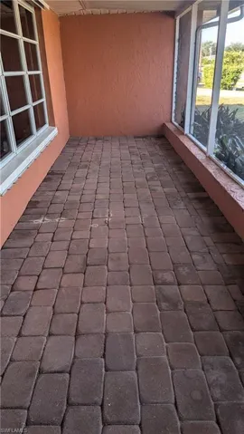 View of patio with a sunroom