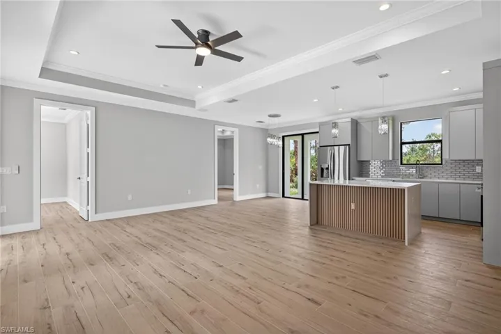 Expansive open-concept living space featuring wood-finish flooring