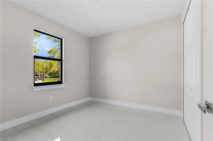 Spare room featuring baseboards