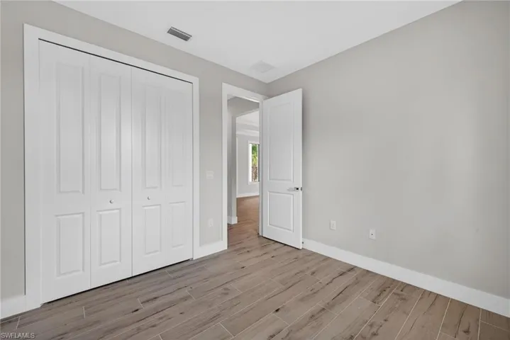 Light gray walls complement the wood-finish flooring