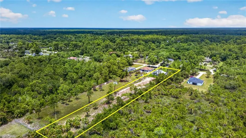 Expansive parcel featuring a cleared building site, mature trees, and a natural landscape