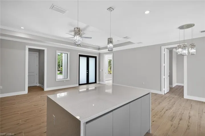 Central island featuring a light-toned countertop