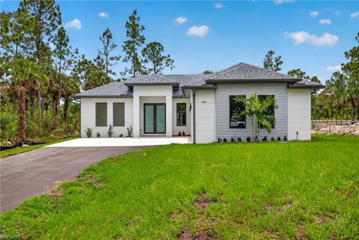 Contemporary single-story residence with a gray shingle roof and a stucco and horizontal siding facade