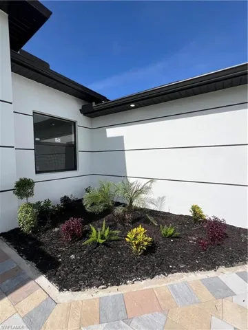 View of side of property featuring stucco siding