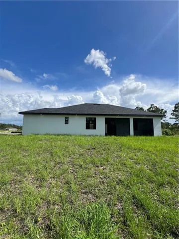 Rear view of property featuring stucco siding