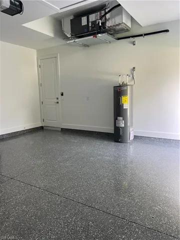 Garage with water heater and a garage door opener