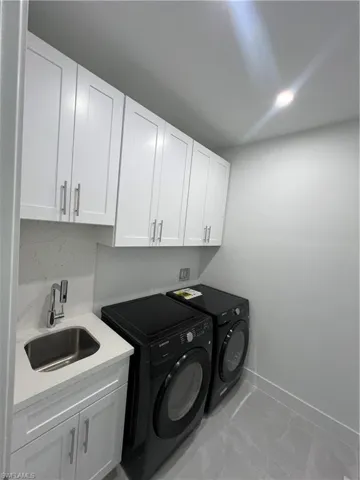 Laundry area featuring cabinet space and separate washer and dryer