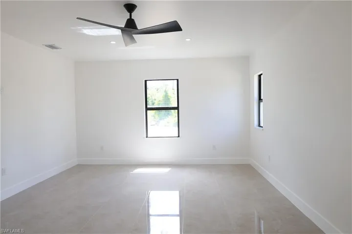 Spare room with plenty of natural light, recessed lighting, and ceiling fan
