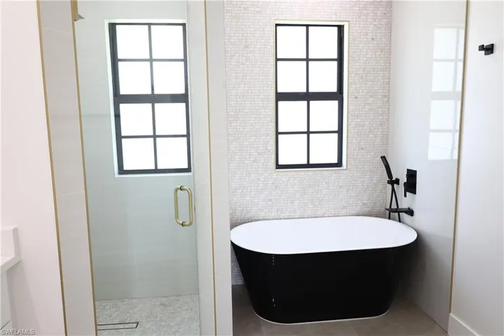 Bedroom with ceiling fan and tile patterned floors