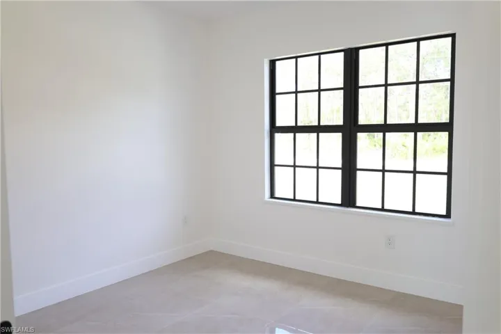 Kitchen with tasteful backsplash, pendant lighting, light stone countertops, recessed lighting, and a kitchen island