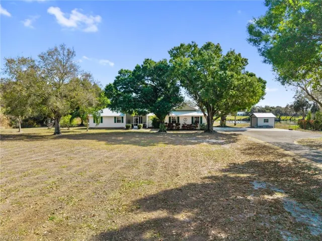 View of grassy yard featuring driveway