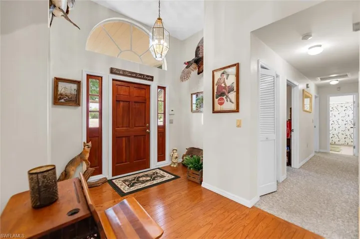 Entrance foyer with a high ceiling and light wood flooring