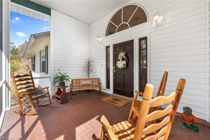 Doorway to property featuring a porch and a patio area