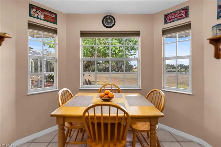 Dining area featuring light tile patterned flooring and healthy amount of natural light
