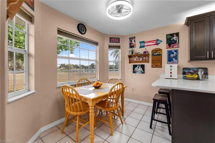 Dining space featuring light tile patterned floors and baseboards