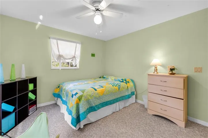 Bedroom featuring ceiling fan and carpet