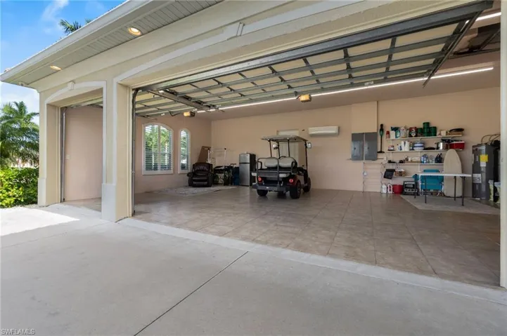 Garage with a wall mounted air conditioner and water heater