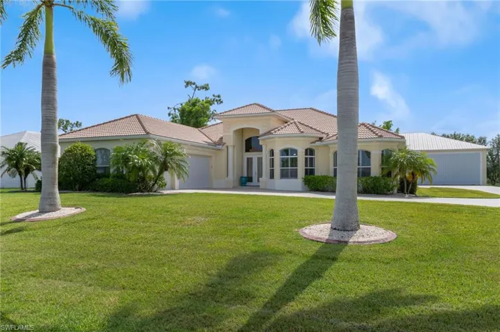 Mediterranean / spanish-style house featuring a garage and a front lawn