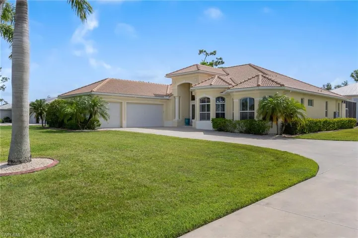 Mediterranean / spanish house featuring a garage and a front yard