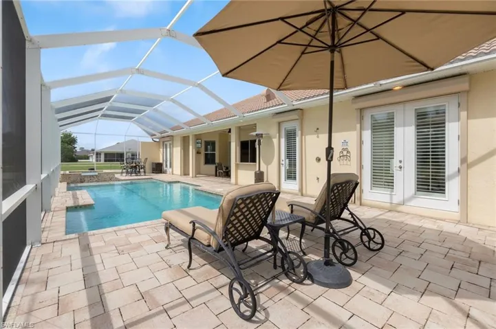 View of swimming pool with a lanai and a patio area