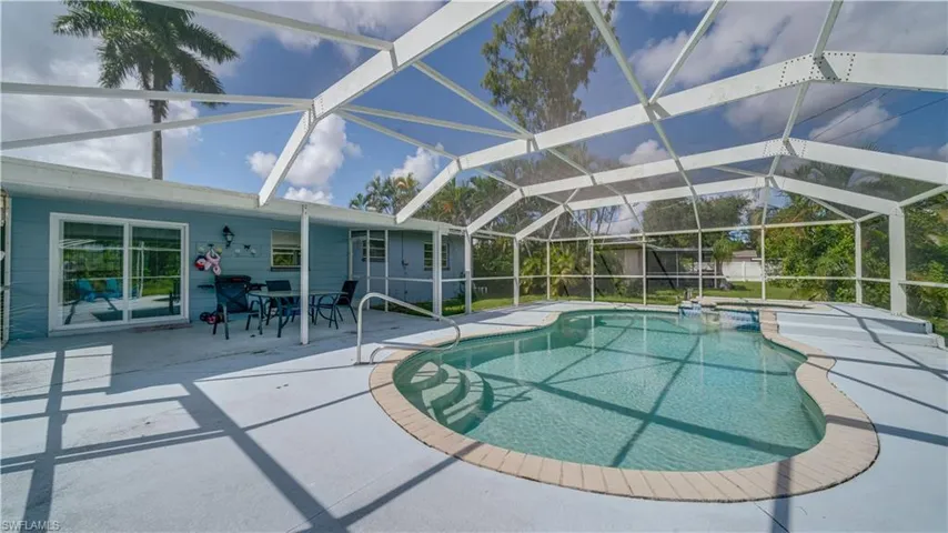 View of swimming pool featuring a lanai and a patio