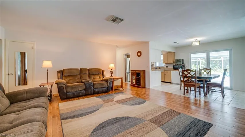 Living room with sink and light hardwood / wood-style floors
