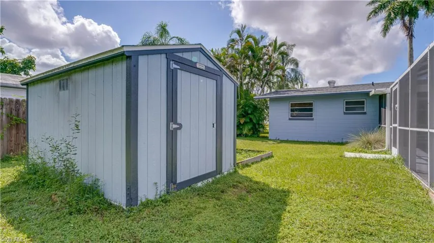 View of outbuilding with a lawn