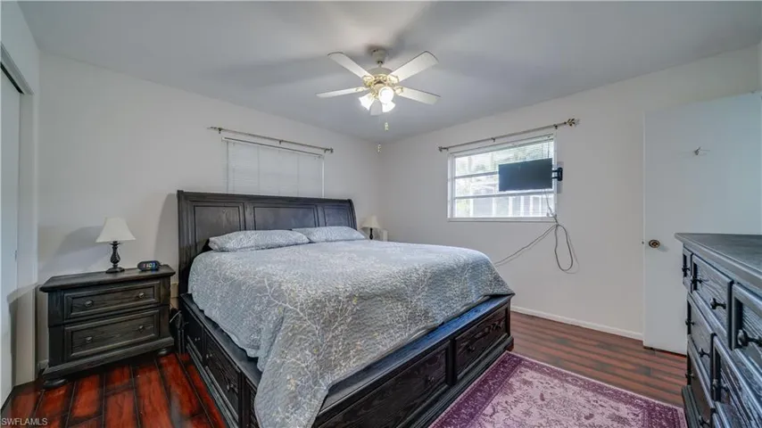 Bedroom featuring ceiling fan and dark hardwood / wood-style floors