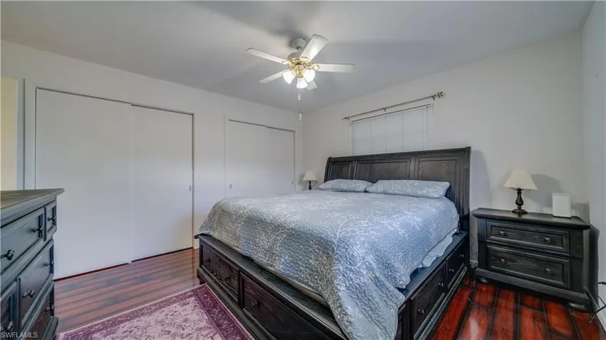 Bedroom featuring dark wood-type flooring and ceiling fan