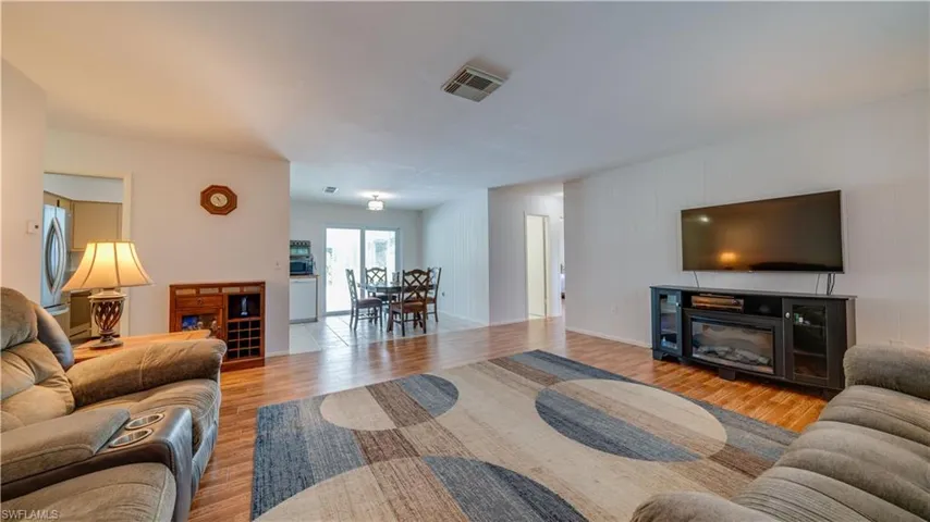 Living room featuring a fireplace, washer / clothes dryer, and light hardwood / wood-style floors