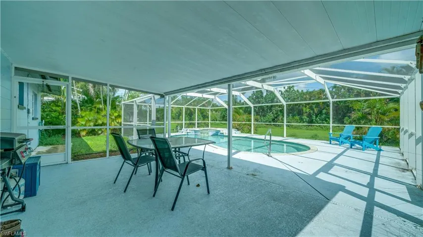 View of pool featuring a lanai, area for grilling, and a patio