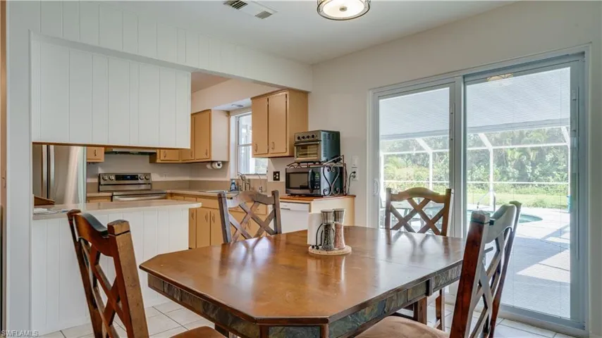 Dining space featuring plenty of natural light, sink, and light tile patterned flooring