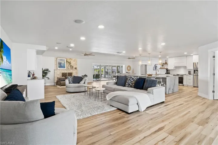 Living area with light wood-style flooring, recessed lighting, a ceiling fan, baseboards, and visible vents