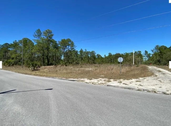 View of asphalt road featuring traffic signs