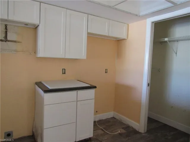 Laundry room featuring dark hardwood / wood-style flooring