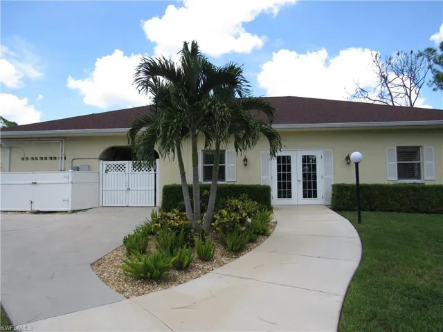 Single story home with a front lawn and french doors