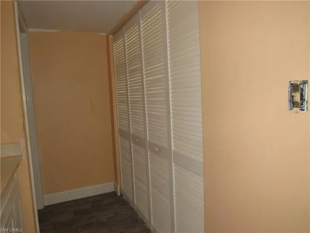 Hallway featuring dark wood-type flooring
