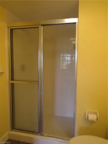Bathroom with a shower with shower door and toilet