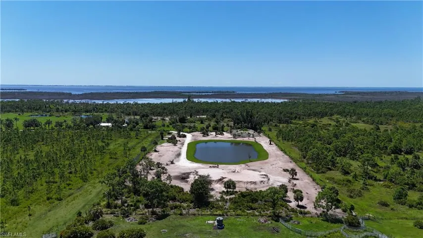 Drone / aerial view of a large body of water and a heavily wooded area