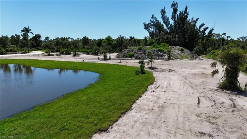 View of community featuring a water view and a yard