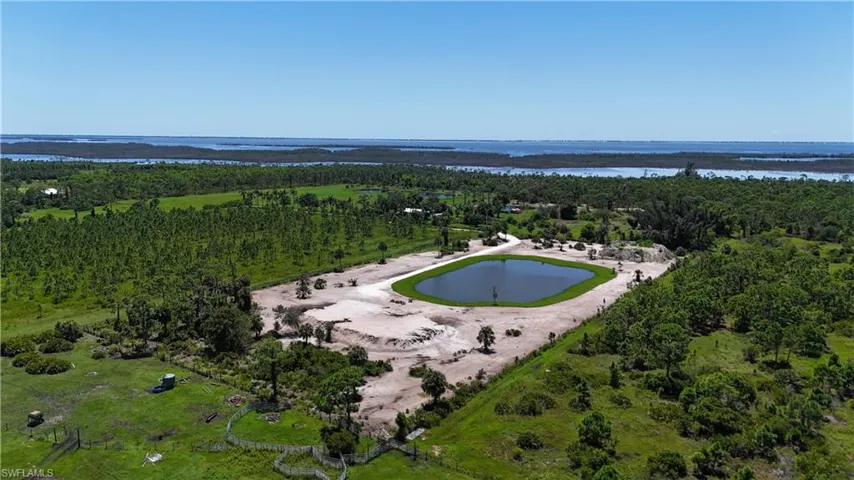Bird's eye view of a nearby body of water and a heavily wooded area