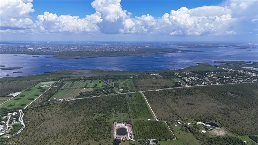 Aerial view of sparsely populated area with extensive farmland and a large body of water
