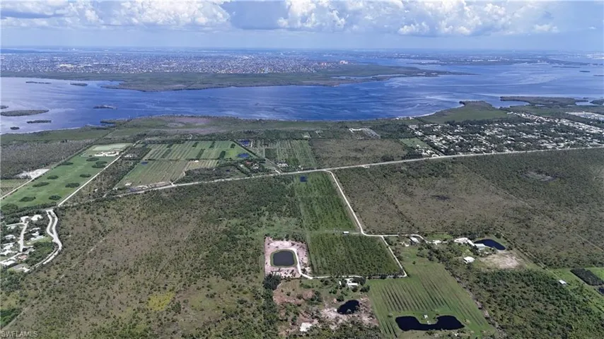 Aerial view of sparsely populated area featuring large plots for crops