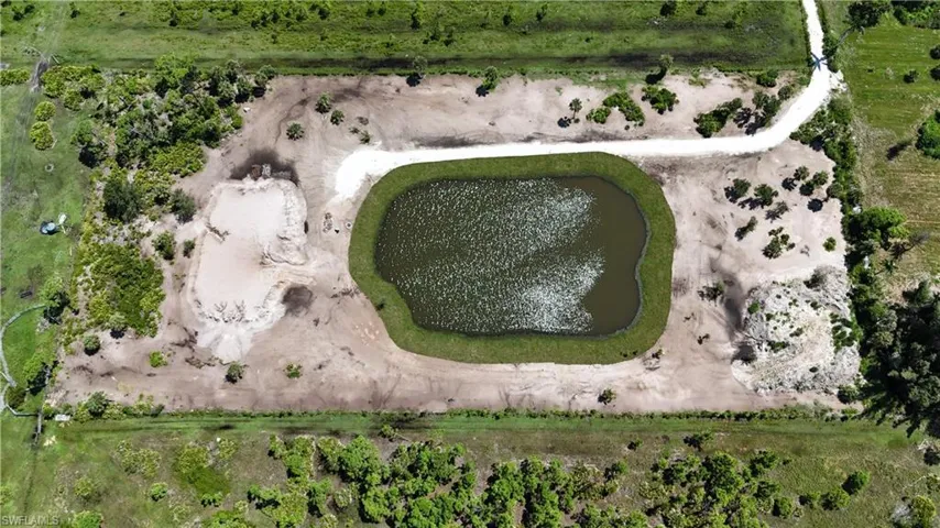 Aerial view of property's location featuring a large body of water