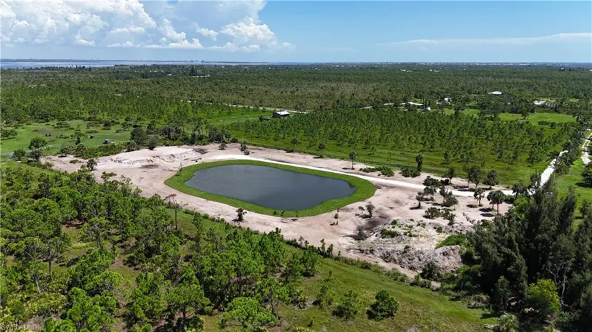 Aerial view of a large body of water and a heavily wooded area